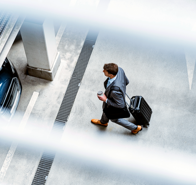 A man is walking towards his car in free-flow parking facility