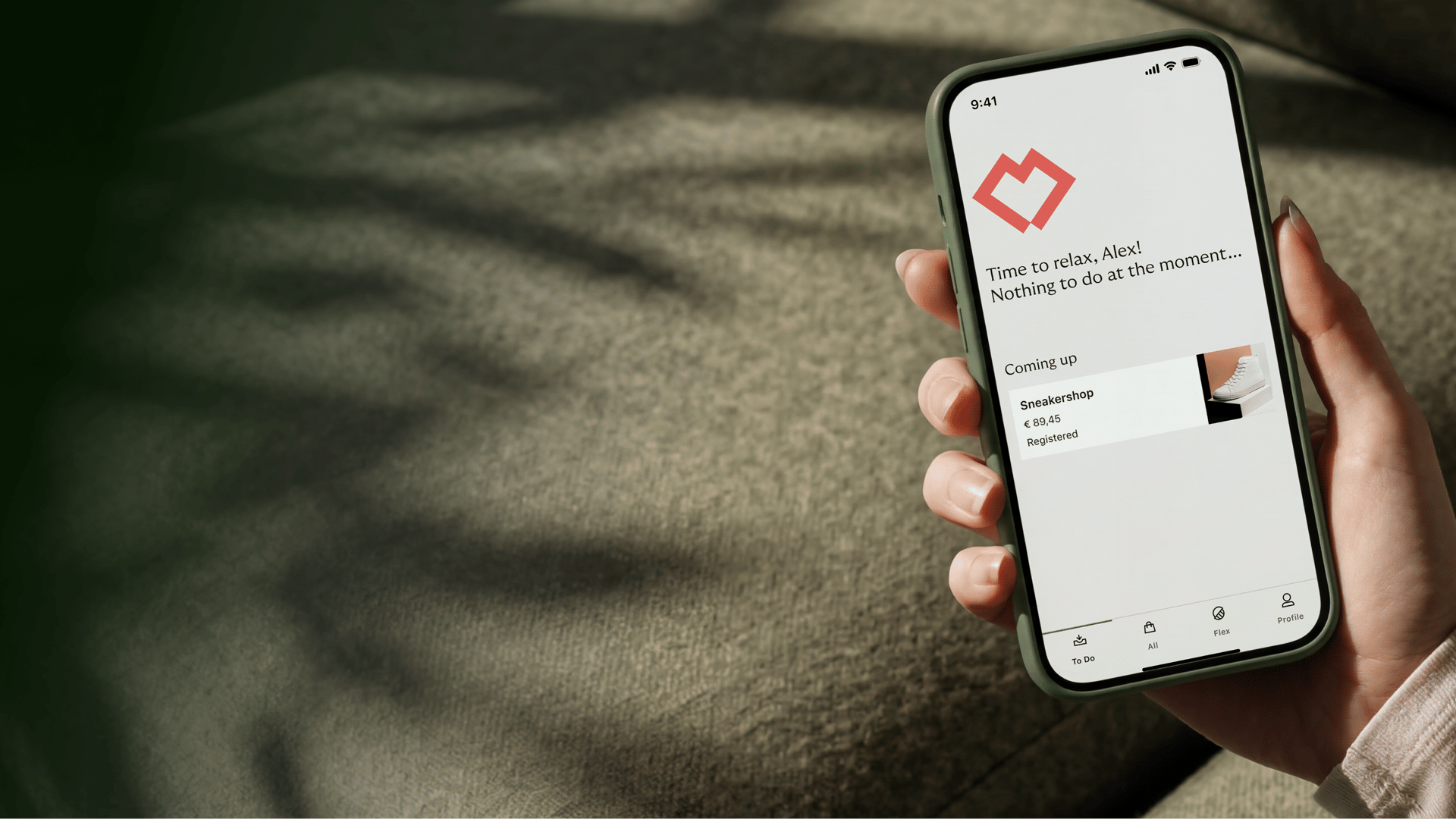 a hand holding a phone with the Riverty app open