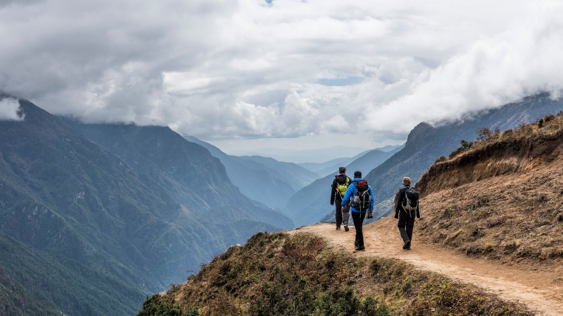 three people hiking 
