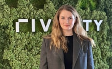 Anna Albert standing in front of a Riverty sign