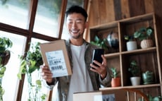 Man smiling at his package.   