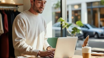 Man behind laptop next to a street