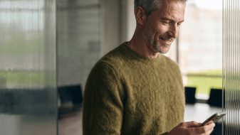 Man smiling looking at his phone