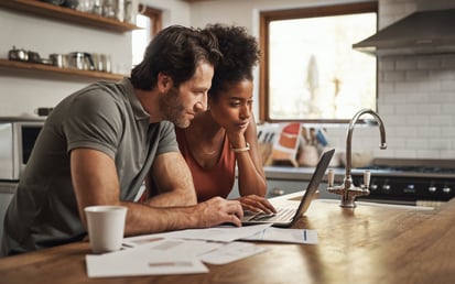 Couple looking at their budget on a computer screen