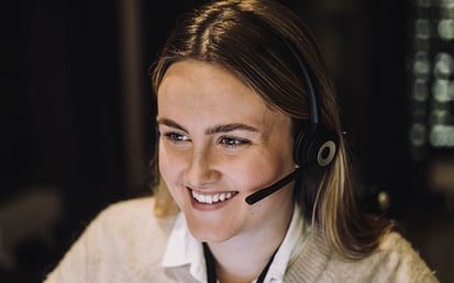 Woman smiling with a headset