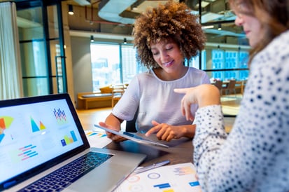 two girls in front of a laptop