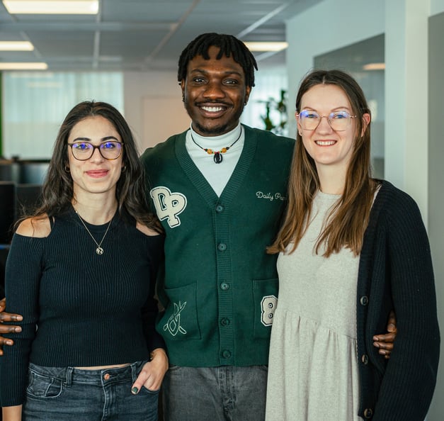 three employees looking into the camera