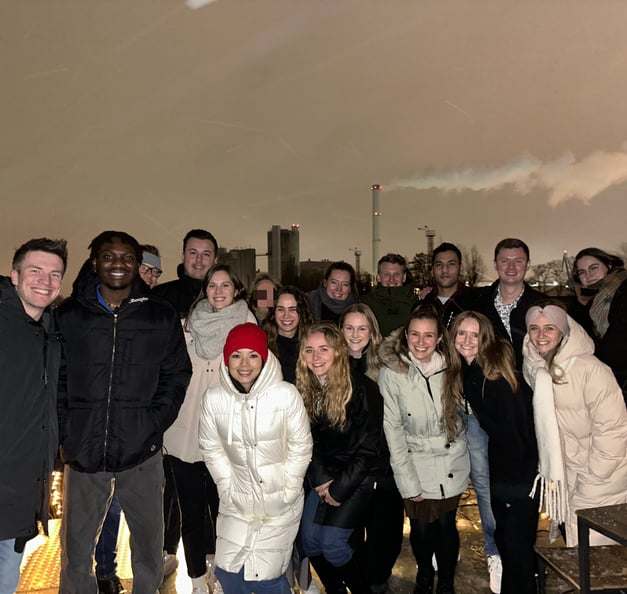 An outdoor group picture of Timothy and 17 other Riverty employees
