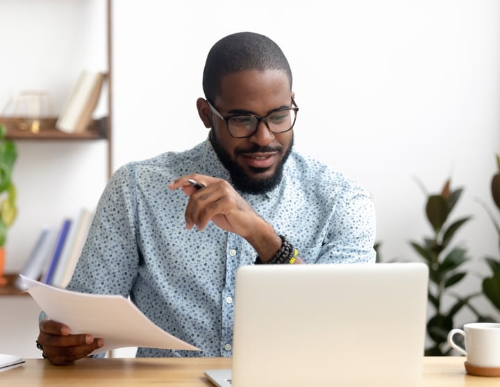 A man sitting next to his computer