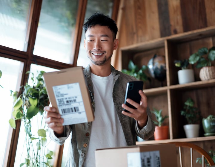 Man smiling at his package.   