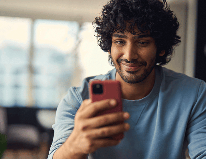 Man smiling at phone