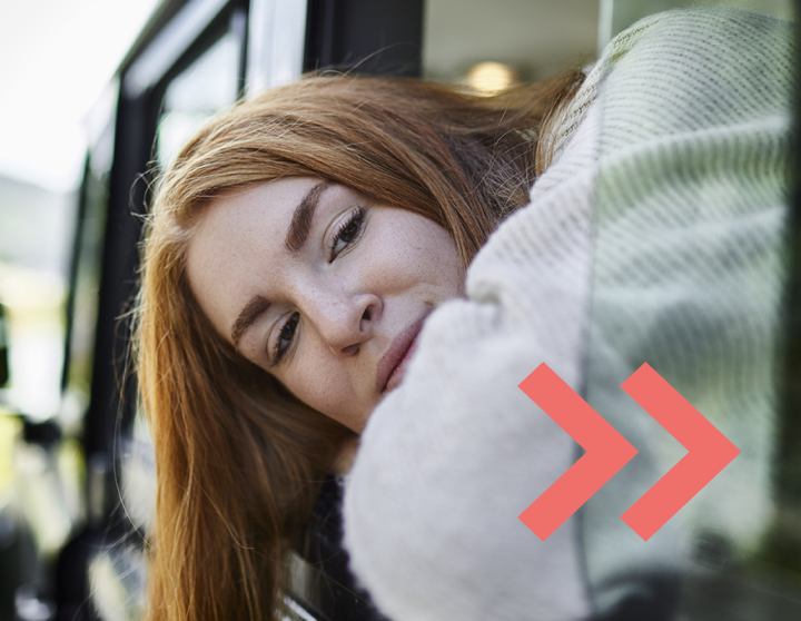 Woman looking out of the window of a car